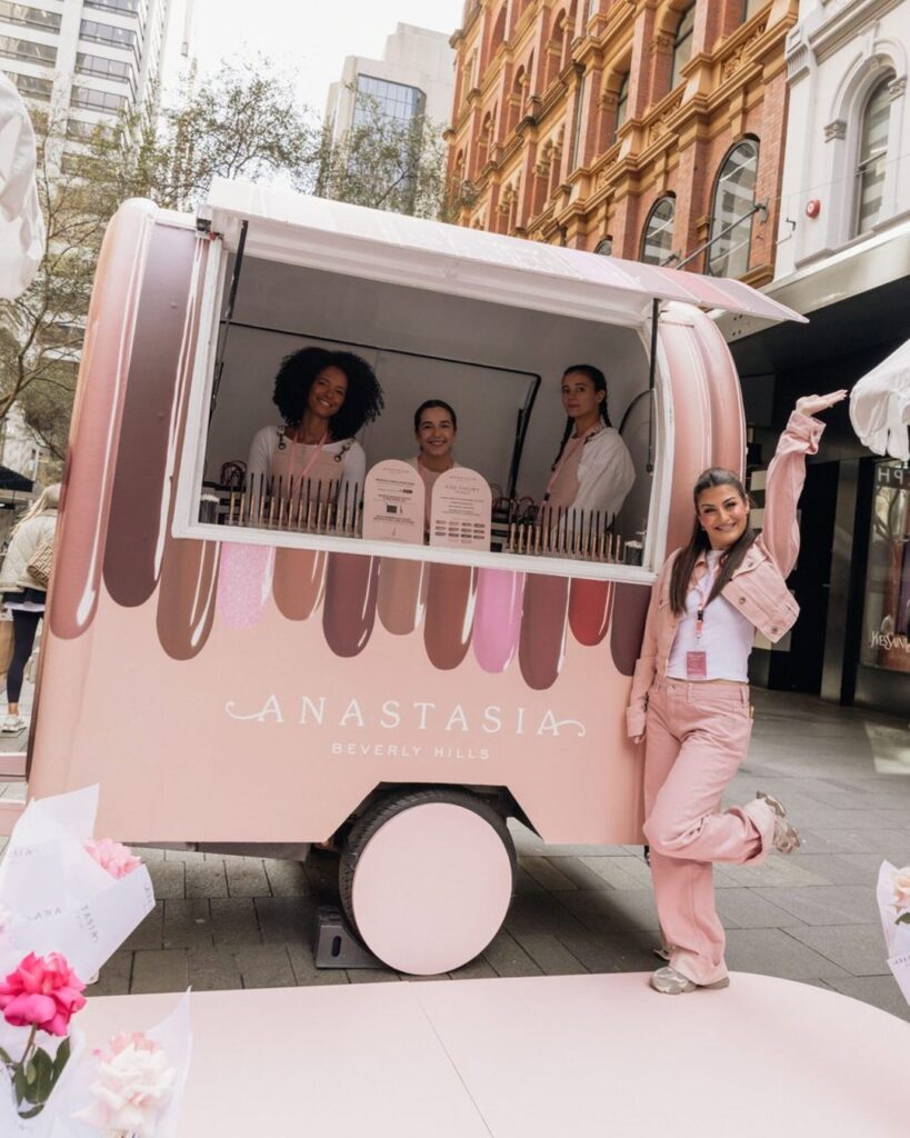 Anastasia Beverly Hills custom pink branded trailer with brand ambassadors at a street activation, produced by Woofys