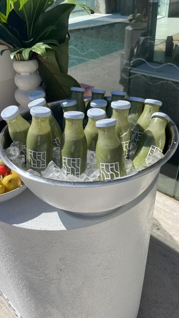 Branded green smoothies on ice poolside